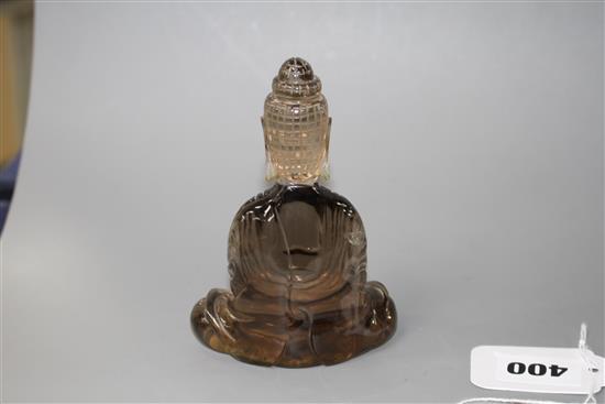 A Chinese smoky quartz seated figure of Guanyin, 19th/early 20th century, H. 11.5cm